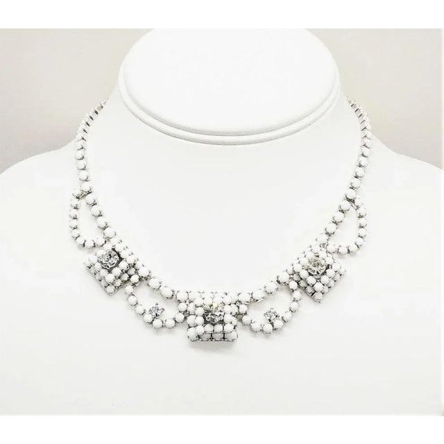 This is part of Chairish’s Costume Jewelry assortment. 1960s rhodium plated prong set white cabochons with clear swarovski...