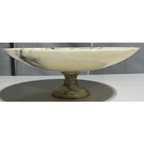 An elegant early 20th-century Italian tazza centerpiece carved from richly veined marble. The shallow circular bowl rests...