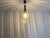 Vintage pendant light from former Yugoslavia, dating from the 1970s. The design combines a warm amber-colored textured...