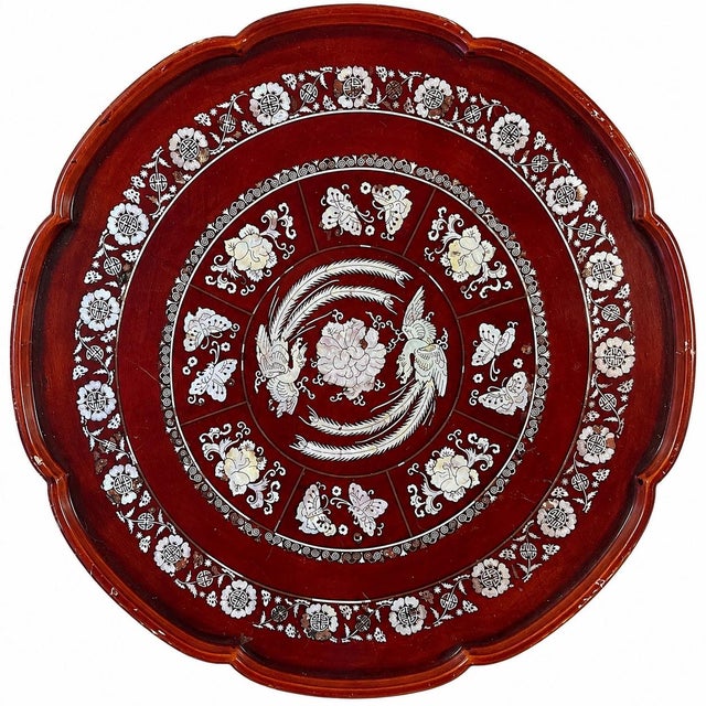 Striking vintage Korean lacquer folding tea table featuring an elaborate hand-inlaid mother-of-pearl decorative surface in...