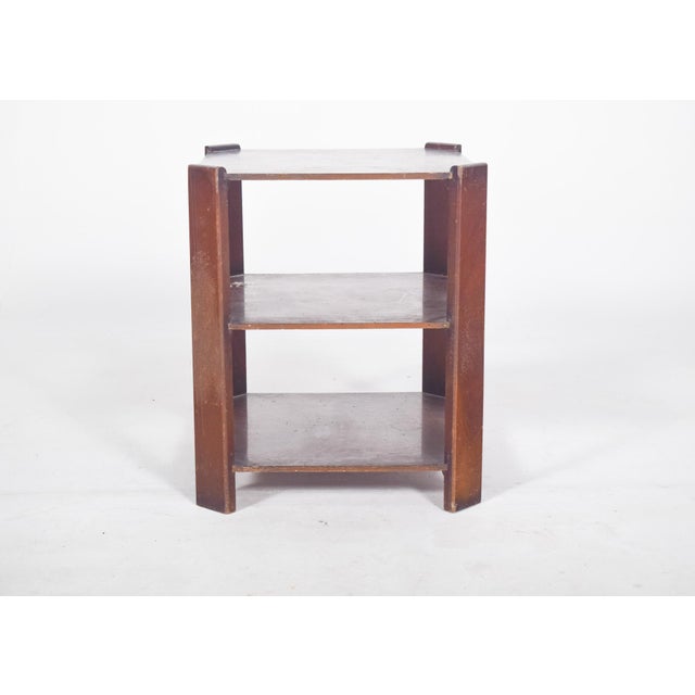 Deco coffee table. With top, middle shelf and bottom base, all in wood with a dark varnished finish. The sides are made up...