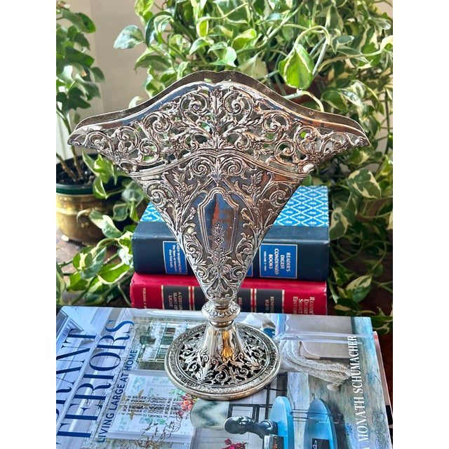 A home cannot have enough vases and the more varied styles, the better. This silver plate (over brass ) fan shaped vase...