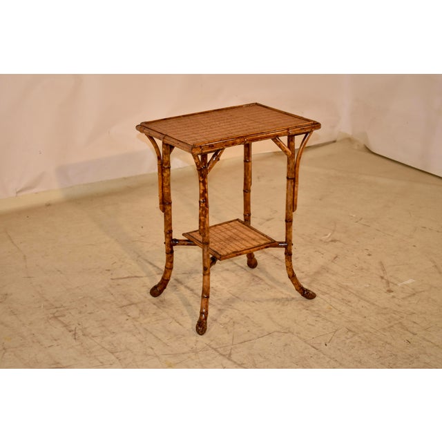 19th century tortoise bamboo side table from France. The top has bamboo banding around the edge of the rush covered top....