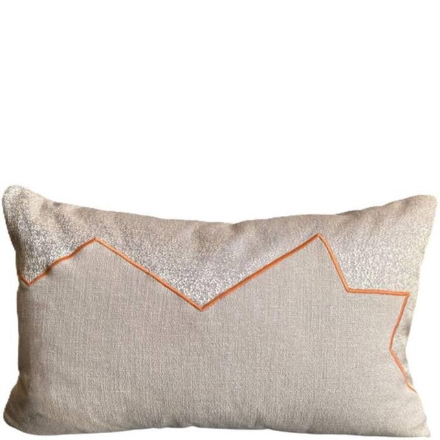 Nial combines 2 neutral fabrics, joined along an ìrregular line with with a cordonetto embroidery in a contrasting amber...