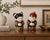 Charming vintage pair of hand-painted Chinese porcelain figurines depicting a traditional boy and girl dressed in richly...