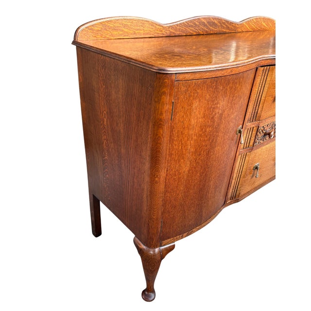 This antique American buffet dates to the late 1920s or early 1930s and showcases beautiful quarter-sawn oak construction...