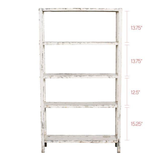 Vintage wood free-standing shelves with chipping white paint. Simple yet stylish piece with the perfect vintage patina and...