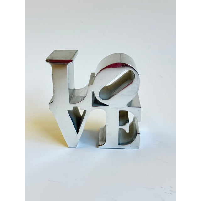 Fantastic 1970s Robert Indiana Pop Art LOVE paperweight in cast aluminum. Robert Indiana's pop art Love design was...