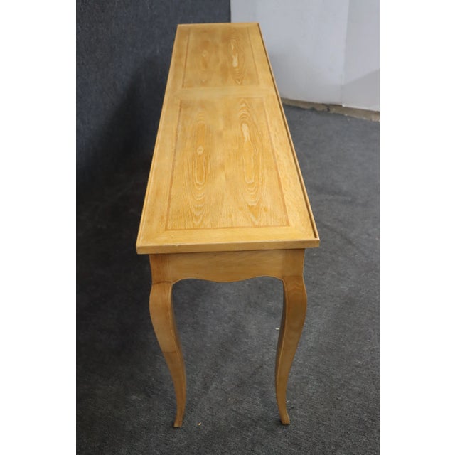 Louis XV style oak console with two drawers and brass hardware.