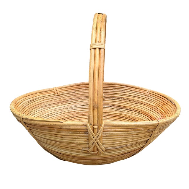 A striking large-scale handwoven split reed rattan basket featuring an elegant sculptural silhouette and dramatic arched...