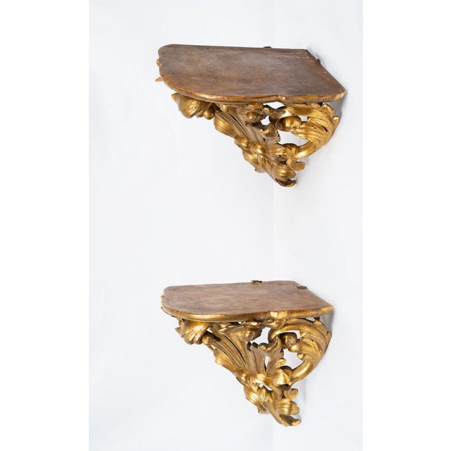 Pair of Louis Philippe corner shelves in gilded and carved wood dating from the first half of the 19th century. The...