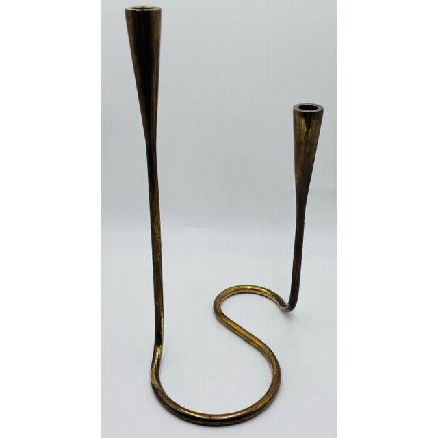 A solo to a pair of brass serpentine double candlesticks by Illums Bolighus. This is a rare chance to pick up a single...