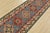 A tribal Caucasian Kazak runner hand-knotted with fine wool on a cotton foundation. This rug features a row of geometric...