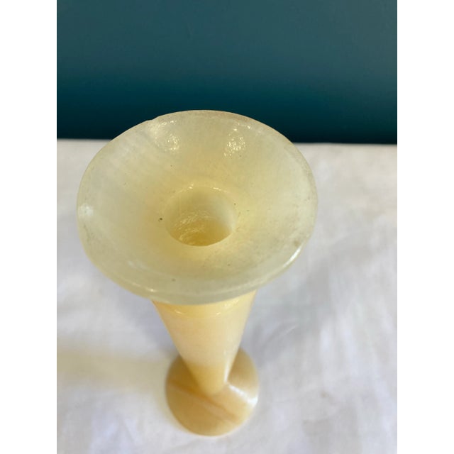 This very pretty alabaster bud vase is expertly carved from a single piece of natural stone, showcasing the soft veining...
