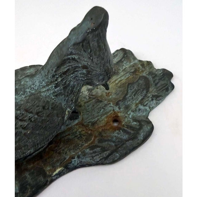 Brass woodpecker shaped door knocker with vintage patina. Visible rust at both screw holes, screws not included.