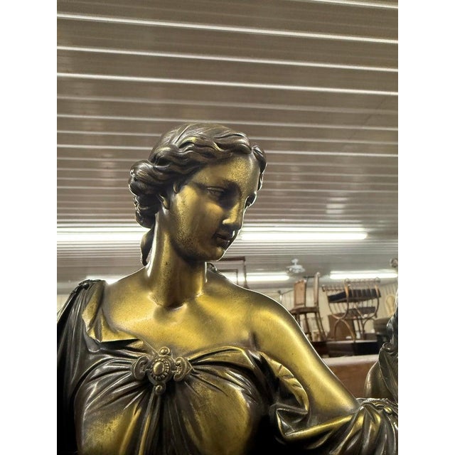 Measures: 20.5 tall x 9 deep x 22 wide. Two pieces. This magnificent French Second Empire (circa 1860) mantel clock is a...