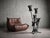 This floor lamp reflects the Brutalist movement of the 1970s, crafted from wrought iron and metal with a matte black...