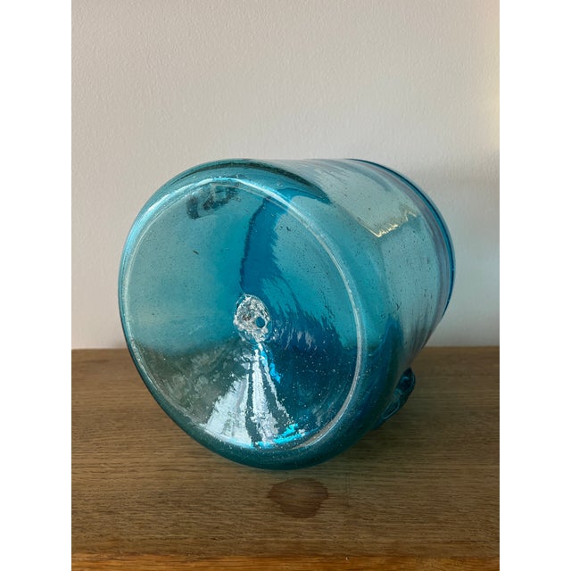 A very heavy, hand-blown glass ice bucket with knob-like handles. A beautiful accent to your bar.