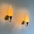 A rare and exquisitely balanced pair of Scandinavian Modern wall lamps dating from the late 1940s, distinguished by their...