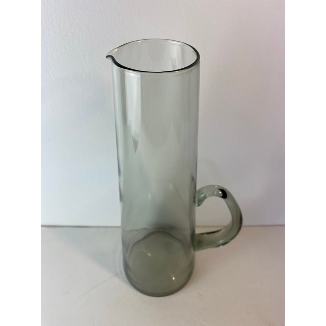 Elegant mid-century modern martini pitcher designed by Per Lütken for Holmegaard, Denmark, circa 1950s–1960s. This hand-...