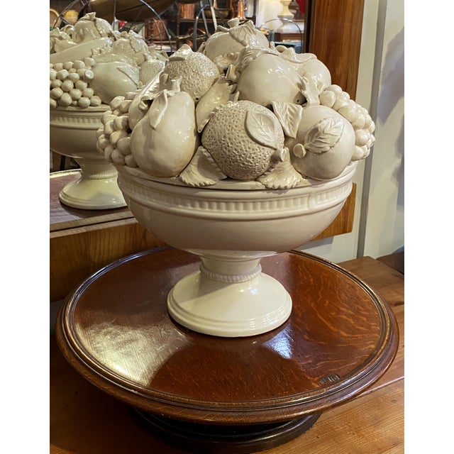 A fine large Italian cream-ware or white glazed ceramic pedestal bowl with mixed fruit topiary top, featuring a fitted lid...