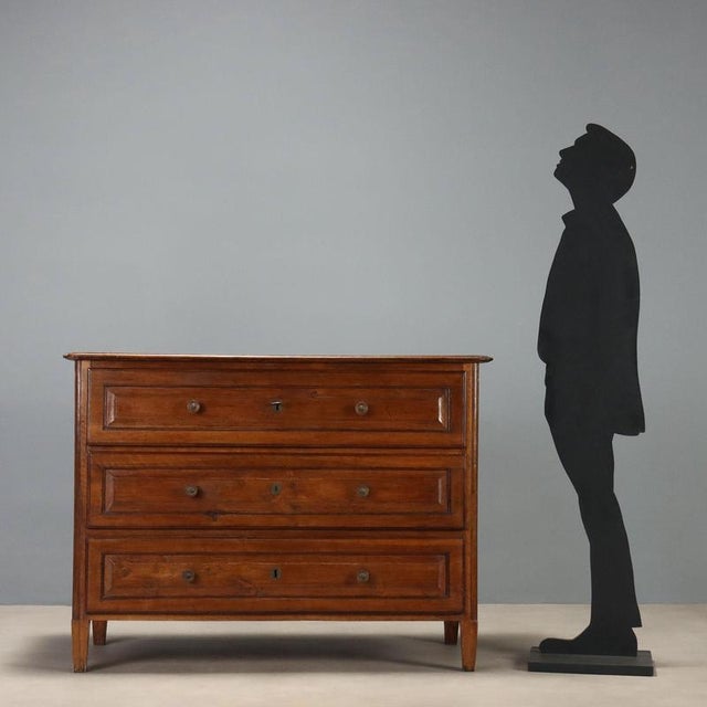 Walnut commode crafted in Italy at the end of the 18th century, featuring an elegant and functional design. The front has...