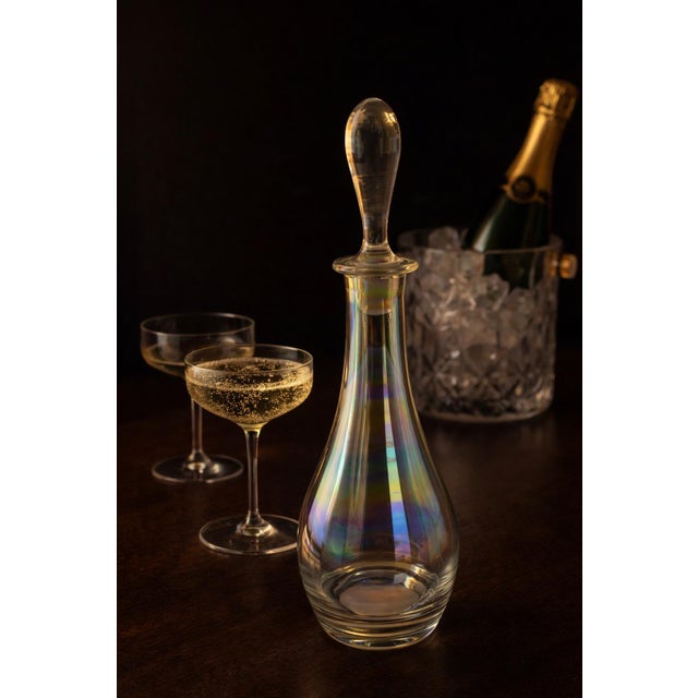A sculptural vintage art glass decanter featuring a soft iridescent “aurora” finish that shifts beautifully in the light....
