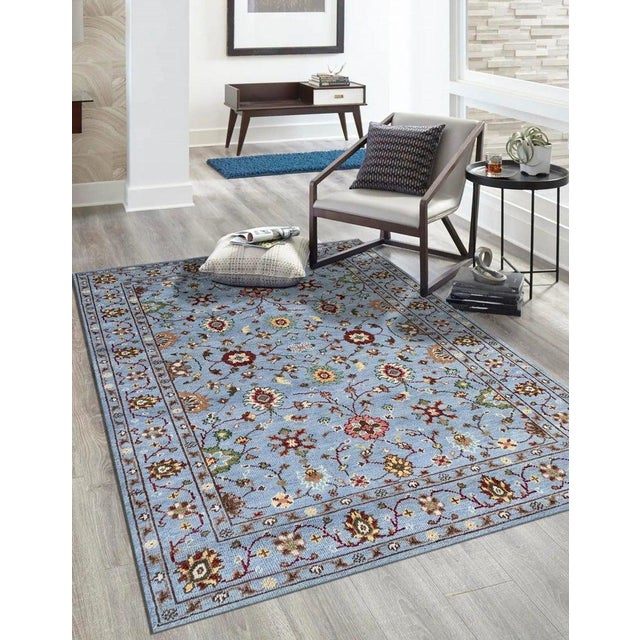 This hand knotted pile rug features a primary blue color and is crafted from wool. It represents a Sarouk style with a...