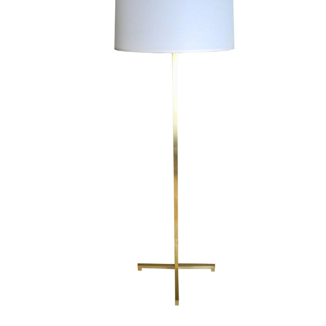 This modern golden brass floor lamp is designed by T.H. Robsjohn-Gibbings for Hansen Lighting. The cross base measures...