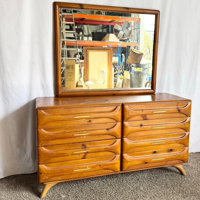 This Mid-Century Modern sculptured pine dresser with mirror by Franklin Shockey Co is a striking example of postwar...