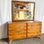 This Mid-Century Modern sculptured pine dresser with mirror by Franklin Shockey Co is a striking example of postwar...