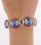 18k white gold oval shaped multi gemstone link bracelet. Featuring 7 oval cut no heat natural blue sapphires. Each of...