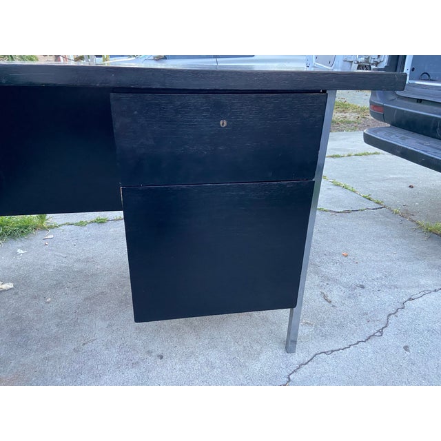 The Vintage Mid Century Florence Knoll Double Pedestal Executive Desk is a fully assembled piece of furniture with a black...