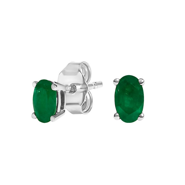 Immerse yourself in the splendor of these resplendent stud earrings, each adorned with a natural, oval-cut green emerald,...