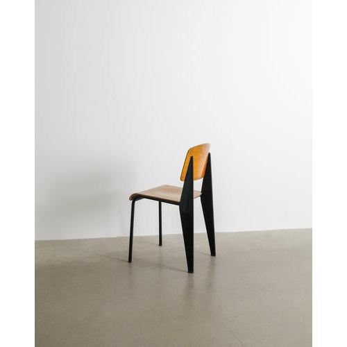 A rare and iconic french mid century "metropole 305 / standard chair" by jean prouvé in black lacquered metal and...