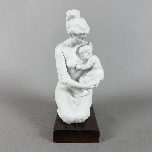 A refined and delicate tabletop sculpture depicting a mother, original and signed by the artist "George," mounted on a...