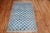 A Mid-20th worn Century Turkish Deco intermediate rug featuring a repetitive all-over design on a vivid blue ground...