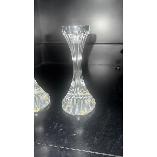 An exquisite pair of authentic Baccarat clear lead crystal candlestick holders in the iconic, highly coveted "Massena"...