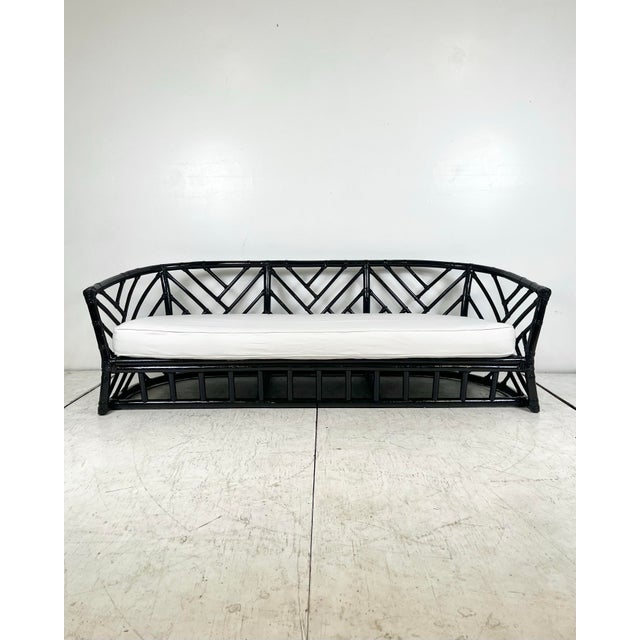 Vintage rattan Chinese chippendale sofa. Rounded frame with chippendale fretwork panels. Dark brown, almost black glossy...
