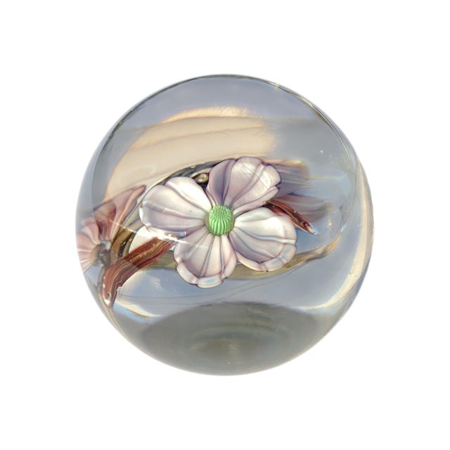 A beautiful Orient & Flume dogwood blossom paperweight capturing the delicate beauty of flowering branches suspended in...