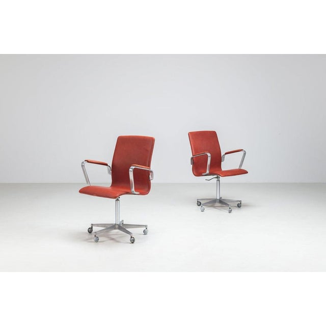 Pair of Arne Jacobsen Model 3291 ‘Oxford’ office chairs in cognac leather and aluminium, produced by Fritz Hansen, Denmark...