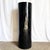 A striking postmodern pedestal defined by its pure cylindrical form and deep black high-gloss lacquer finish. The...