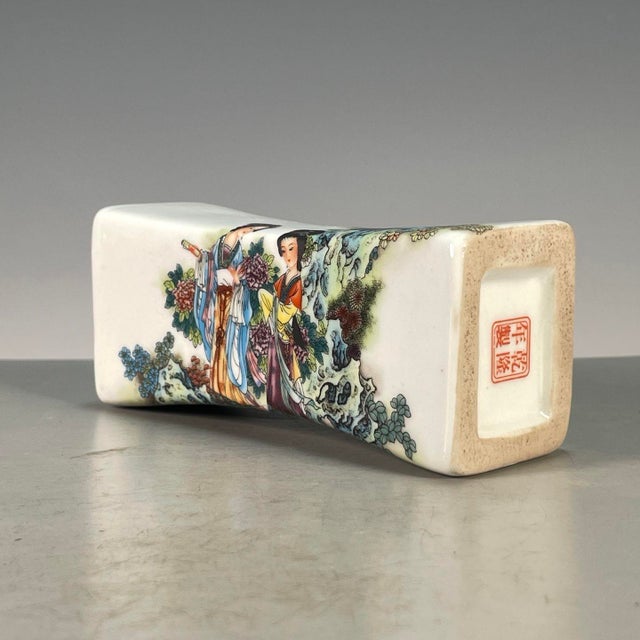 This is an elegant vintage porcelain pillow (瓷枕), also known as a wrist rest (脉枕) or paperweight (镇尺), a traditional...