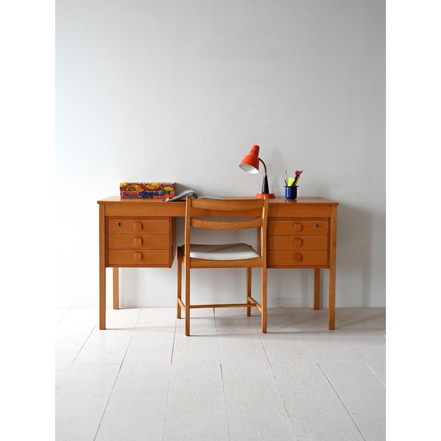 1960s desk with double floating chest of drawers, six drawers with shaped handles, and a light teak frame. A 1960s Danish...