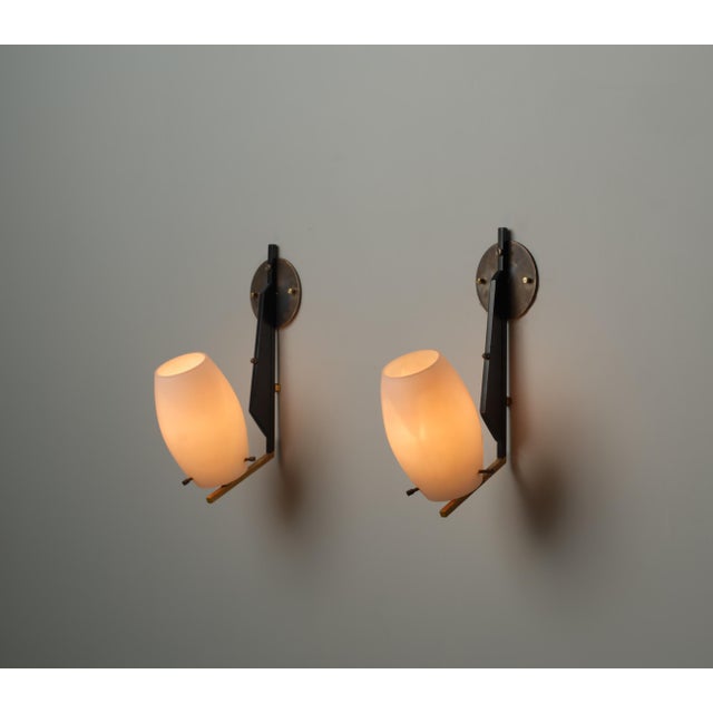 This pair of Italian wall sconces from the 1950s embodies classic mid-century design with refined, minimalist lines....