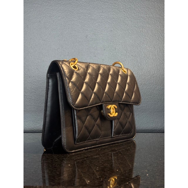 Elevate your collection with this striking Chanel Pocket Flap Bag, a sophisticated fusion of the Maison's iconic heritage...