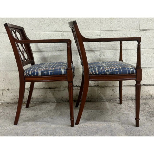 This is a stunning pair of vintage Regency style armchairs with fluted legs and uprights and unique back splats, in the...
