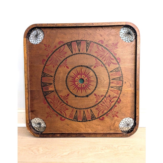 This game board by The Carrom Company from Ludington, MI is estimated to be from the early 20th Century. It is double-...