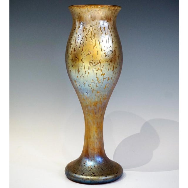 Large, mould-blown vase on a flared foot, widening upwards from a short, slender stem in the shape of a bud, flared rim...