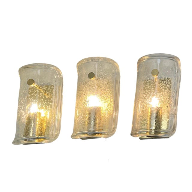 Wonderful high-end wall light fixtures with brass details and thick textured blown glass. Manufactured in the 1960s,...